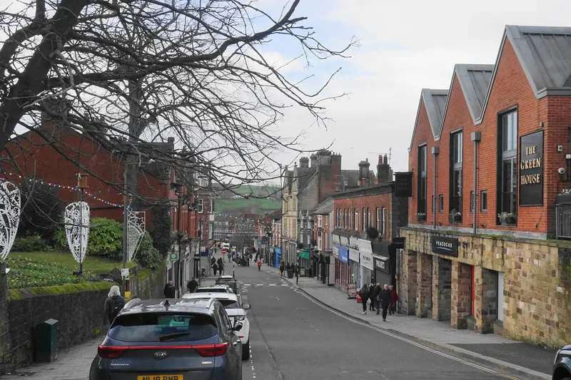 Belper's sloping King Street lined with shops and bare winter trees