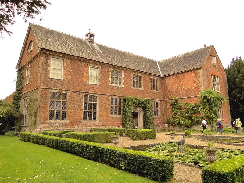 The red-brick manor house of Hellens behind formal box-hedged gardens