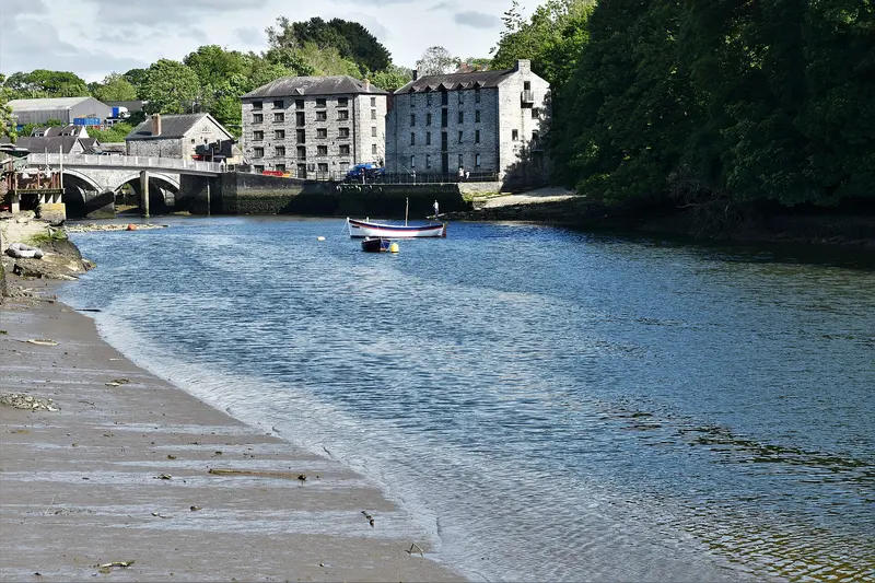 The River Teifi flowing past the old stone bridge and quayside buildings of Cardigan