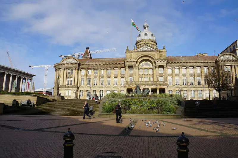 Birmingham's Victoria Square with the domed Council House and the colonnaded Town Hall under a blue sky