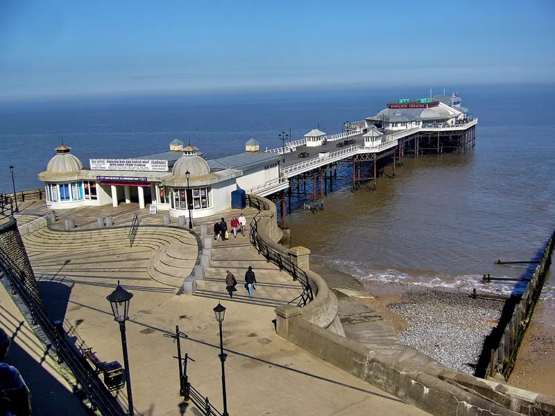 Cromer's Victorian pier and pavilion stretching out to sea, seen from the clifftop promenade