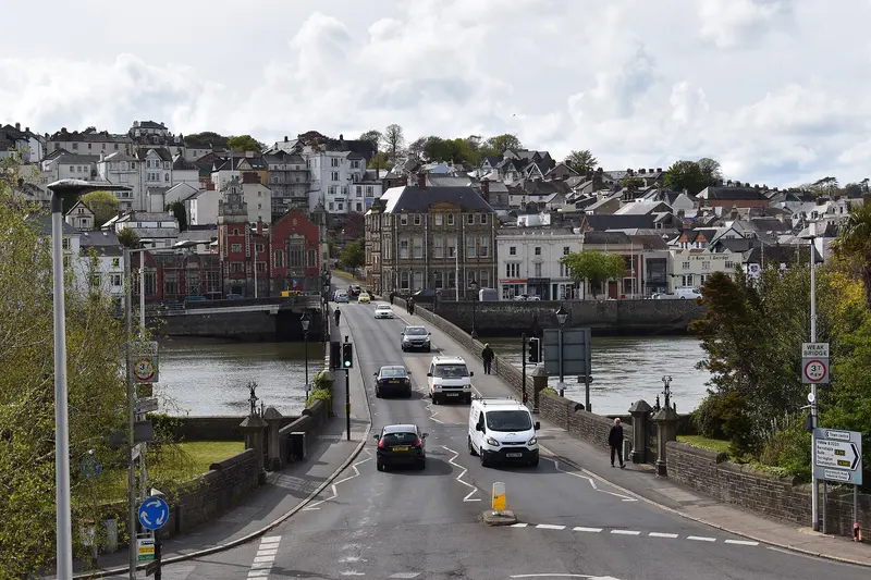 Bideford's long stone bridge crossing the River Torridge, with the quayside and hillside town beyond