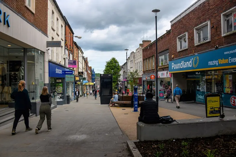 Shoppers on Yeovil's pedestrianised Middle Street, lined with shops under a cloudy sky