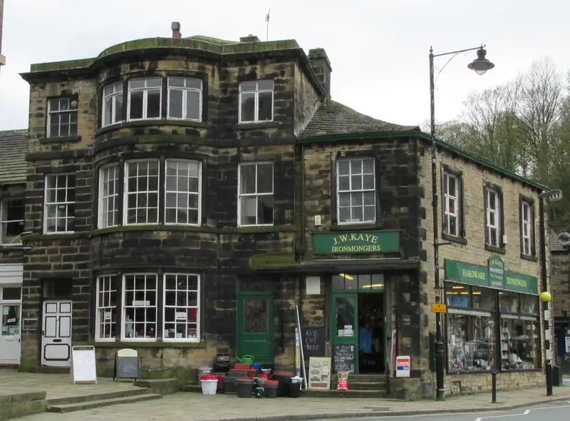 A stone-built Victorian building with shops on Towngate in Holmfirth