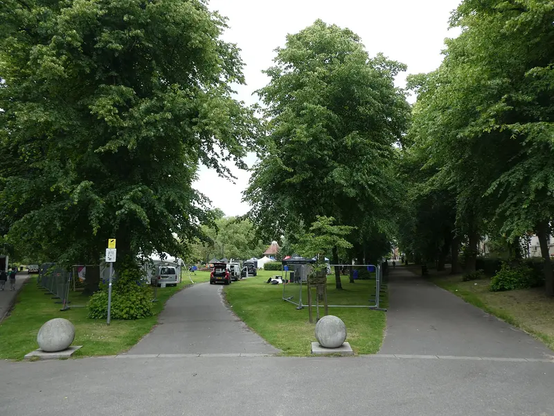 Paths and lawns beneath tall trees in Chapelfield Gardens, Norwich