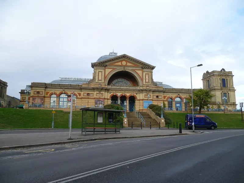 The Victorian Alexandra Palace with its arched central hall and corner towers, seen from the road below