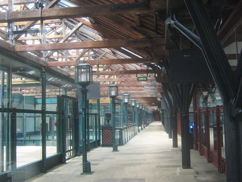 The long brick-and-iron colonnade of the historic Tobacco Dock warehouse in Wapping, with timber roof trusses overhead